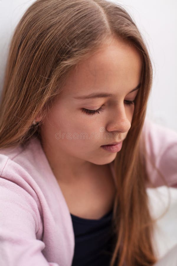 Sad teenager girl with downcast eyes - closeup portrait stock photography Sad teenager girl with downcast eyes - closeup portrait stock photography