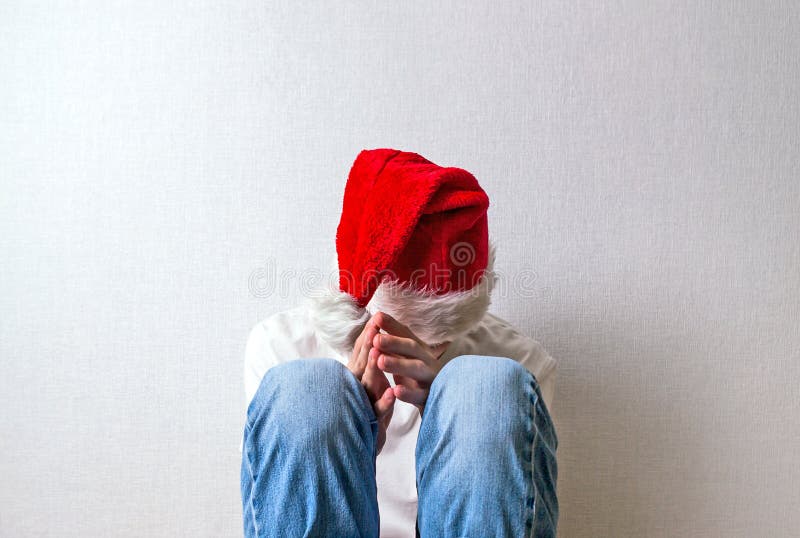 Sad Teenager in Santa Hat royalty free stock image