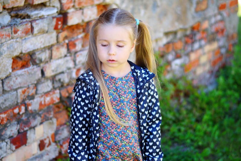 Sad Toddler Girl Standing Near Brick Wall Stock Photo - Image of angry ...