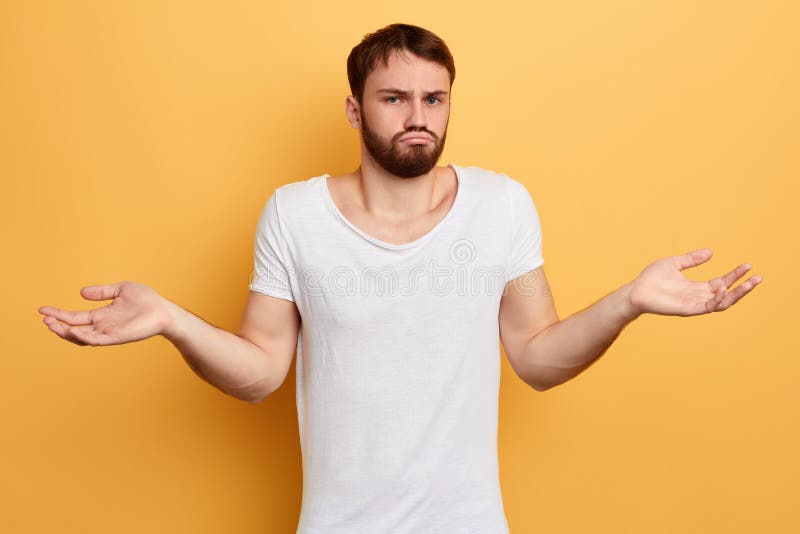 Sad unhappy guy srugging shoulders and looking at the camera stock photography Sad unhappy guy srugging shoulders and looking at the camera stock photography