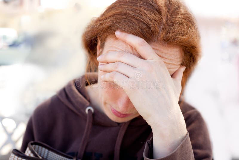 Sad woman with hand in head stock images
