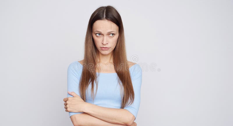 Sad woman with long brown hair. Isolated