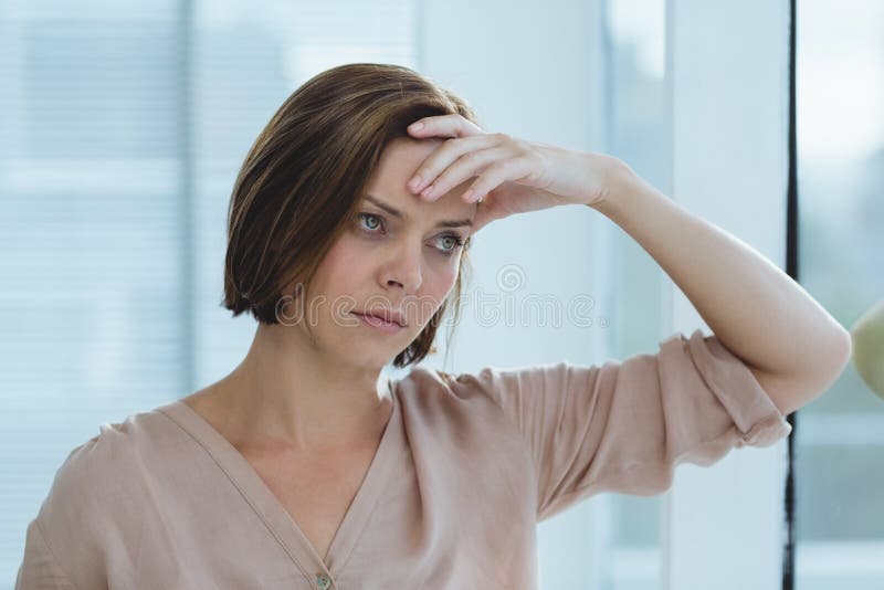 Sad woman standing at home stock image. Image of gloom 77700683
