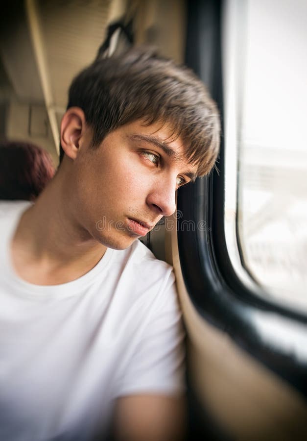 Free Stock Photo of Young Man sitting near window