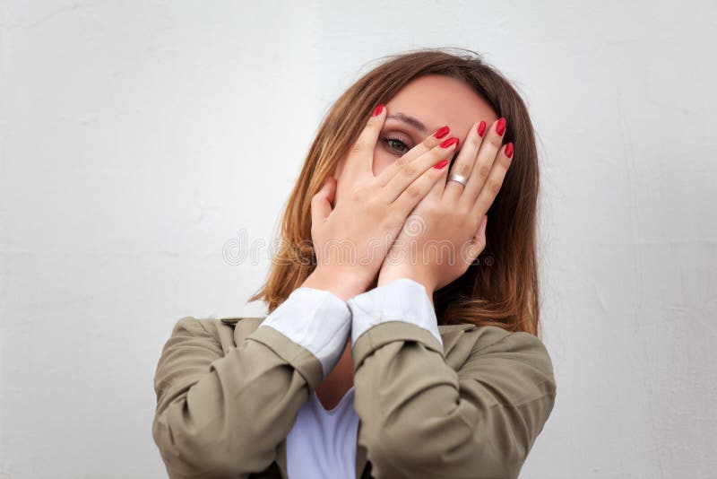 Sad young woman against a white wall. Sad young woman against a white wall