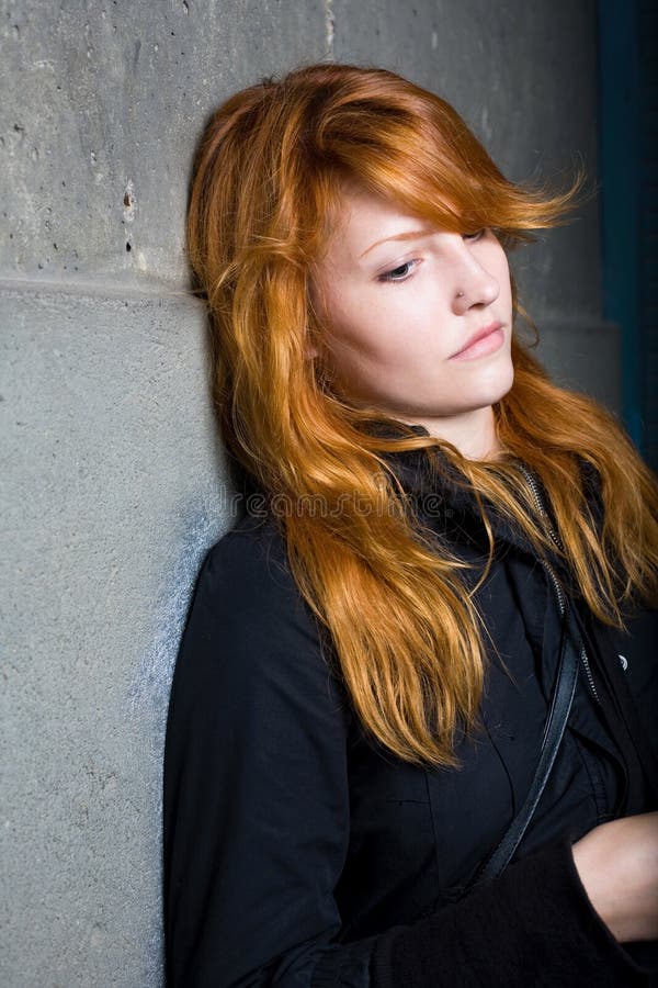 Sadness, moody portrait, beautiful redhead girl.