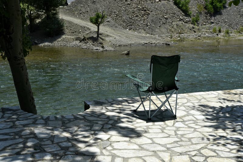 Safari Chair with the View of Zayandeh rood Zayanderud, Esfahan, Iran at the day. Safari Chair with the View of Zayandeh rood Zayanderud, Esfahan, Iran at the day.