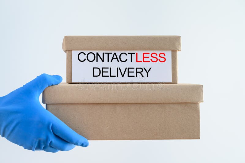 Safe, contactless delivery of parcels to your home during the coronavirus pandemic. Hand of a courier in a blue medical