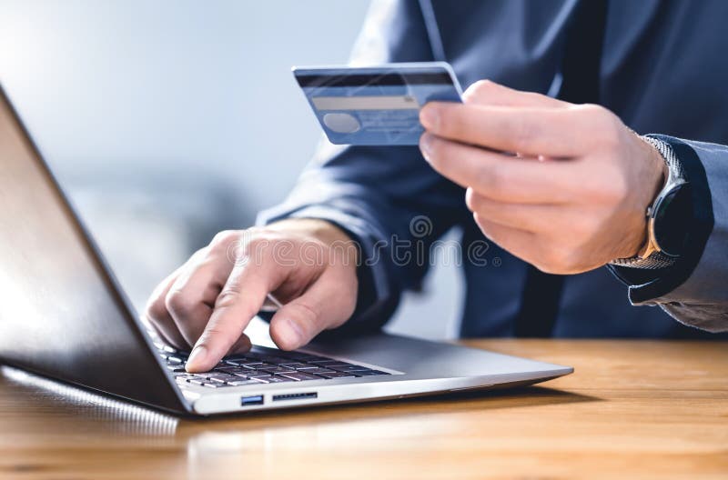 Safe online payment and electronic money transfer security. Pay with digital technology. Man using credit card and laptop.