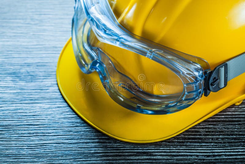 Safety cap glasses on vintage wooden board royalty free stock photography Safety cap glasses on vintage wooden board royalty free stock photography
