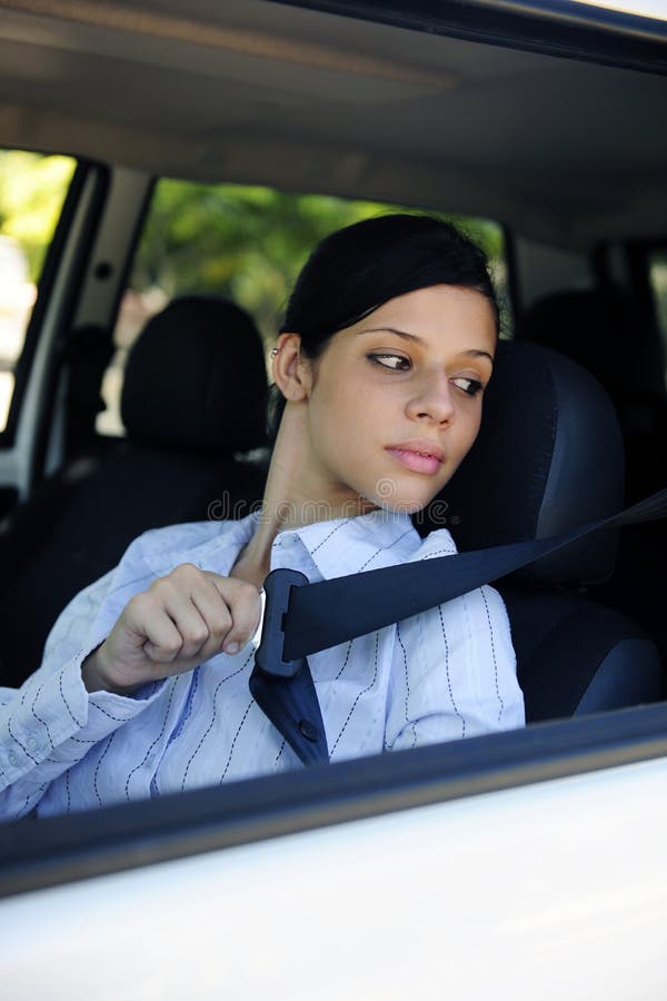 Safety: female driver fastening seat belt