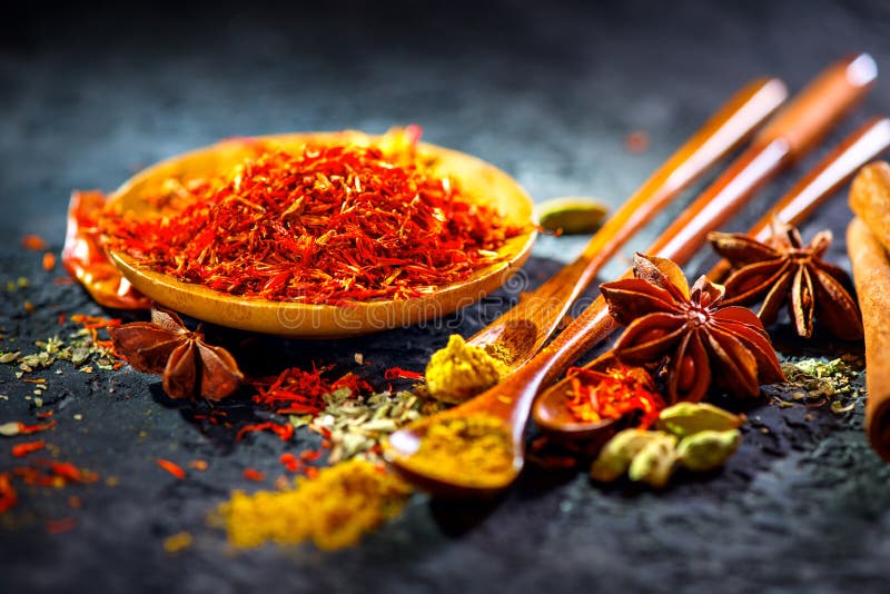 Saffron. Various Indian Spices on black stone table. Spice and herbs on slate background