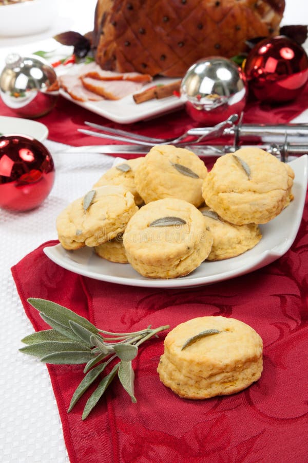 Side dish sage biscuits and carved roasted spiced ham appetizers with Christmas ornaments. Side dish sage biscuits and carved roasted spiced ham appetizers with Christmas ornaments.