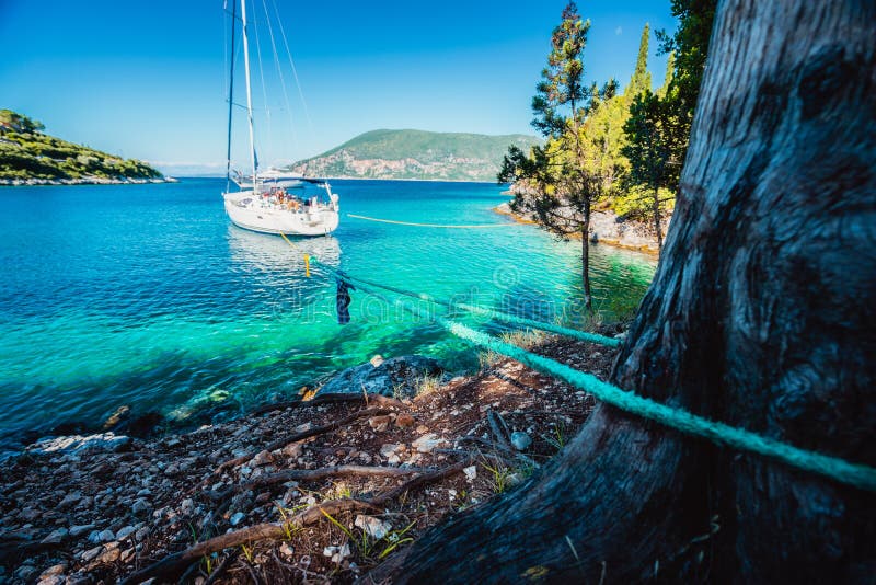 Sail boat docked alone in emerald hidden lagoon among picturesque mediterranean nature Ionian Islands, Greece