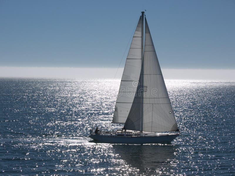 Sailboat gliding on calm sea