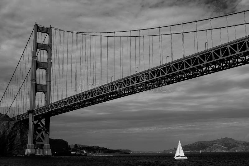 sailboat under bridge