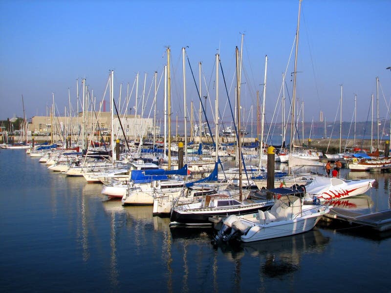 Maze of sailboats reflecting in the Belem district of Lisbon, Portugal.