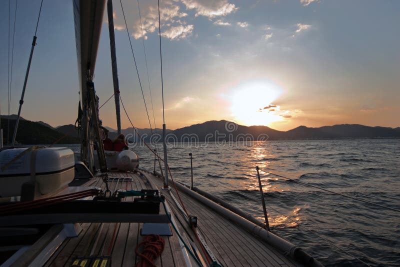 Sailing boat in the sea at sunset