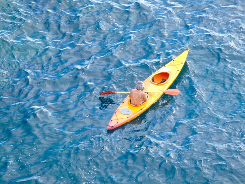 Man sailing in Kayak through the waters of the sea royalty free stock photos Man sailing in Kayak through the waters of the sea royalty free stock photos