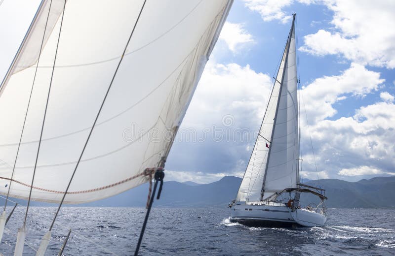 Sailing. Racing yacht in the Mediterranean sea on the background of a stormy sky. royalty free stock image Sailing. Racing yacht in the Mediterranean sea on the background of a stormy sky. royalty free stock image