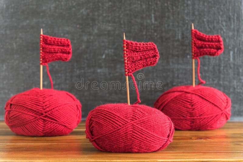 Sailing ships made from red yarn and knitting needles