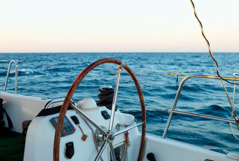 Sailing yacht control wheel, blue sea on background royalty free stock photos Sailing yacht control wheel, blue sea on background royalty free stock photos