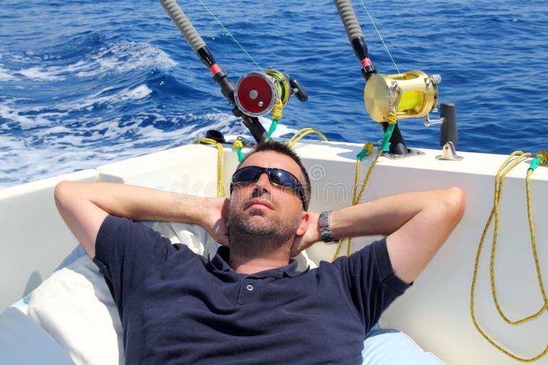 Sailor man fishing resting in boat summer vacation blue sea