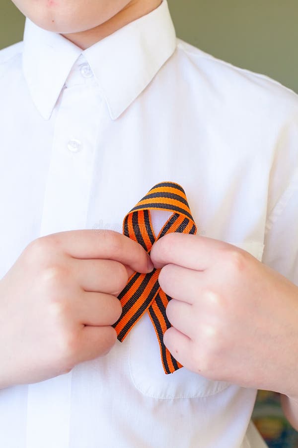 saint george striped ribbon on man clothes. 9 may victory day in russia. saint george striped ribbon on man clothes. 9 may victory day in russia