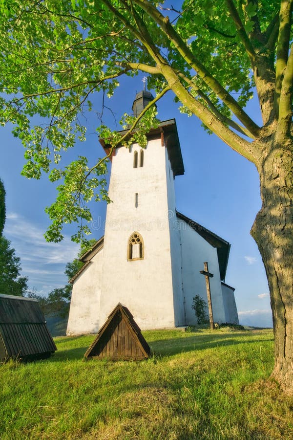 Saint Martin's Church in Martincek with wooden marquises around during summer sunset