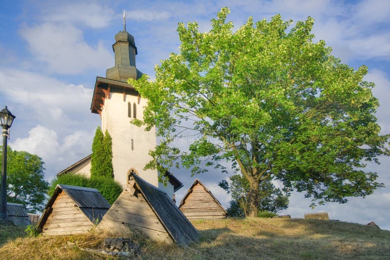 Saint Martin's Church in Martincek with wooden marquises around during summer sunset