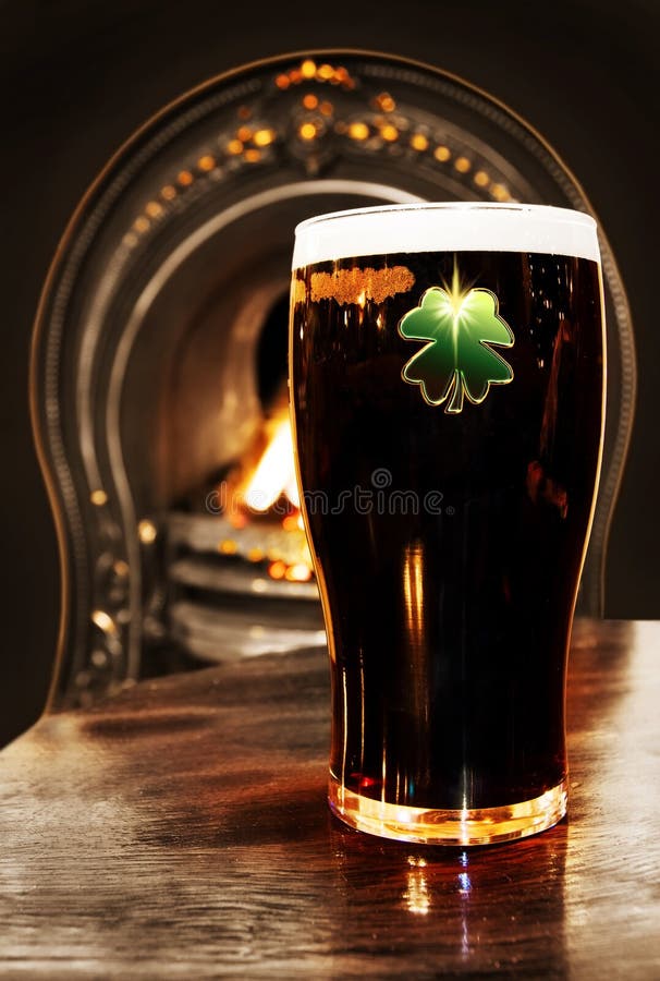 Saint Patrick celebration - Irish black beer with magic shamrock shot over the fireplace inside a Dublin pub. Saint Patrick celebration - Irish black beer with magic shamrock shot over the fireplace inside a Dublin pub.