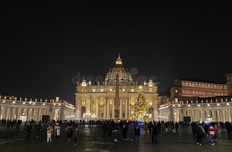 Rome, Italy: 01 January, 2022: view of Saint Peter`s Basilica with a big christmas tree and people in the square.