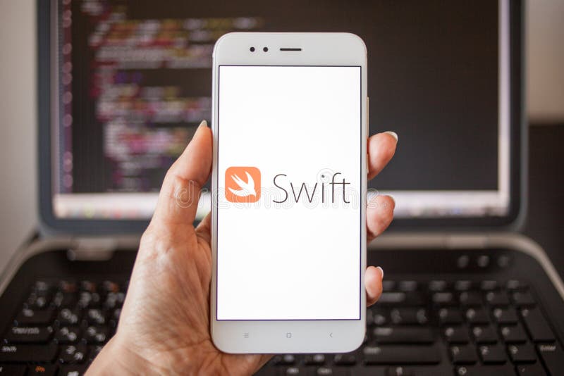 SAINT PETERSBURG, RUSSIA - MAY 16, 2019:Mobile application development, programming language for mobile development. Smartphone in hand with the inscription Swift on the screen. illustrative editorial.