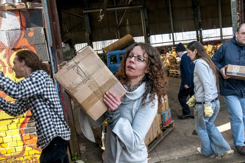 Sakeenah Feghir from BookCycle UK carring a box of books