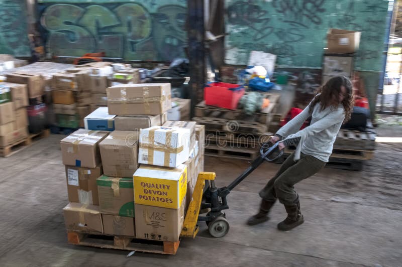 Sakeenah Feghir from BookCycle UK pulling a pallet of books