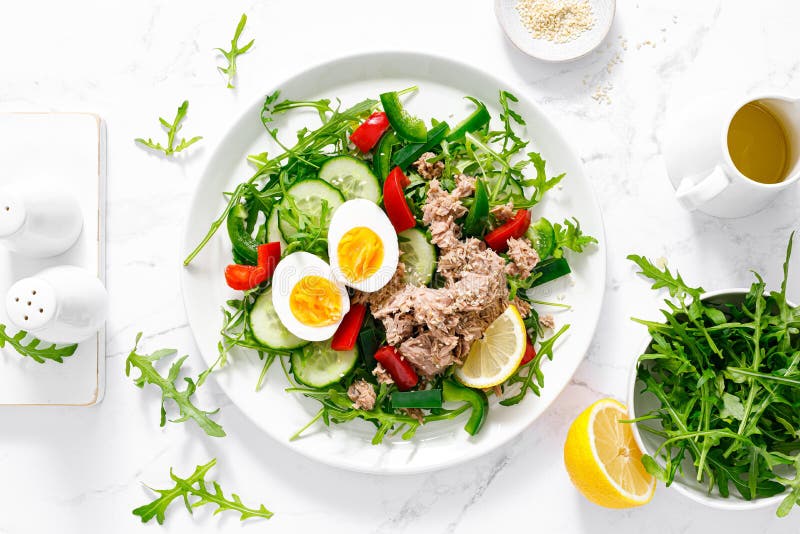 Salad with Canned Tuna, Boiled Egg, Arugula and Fresh Vegetables. Top