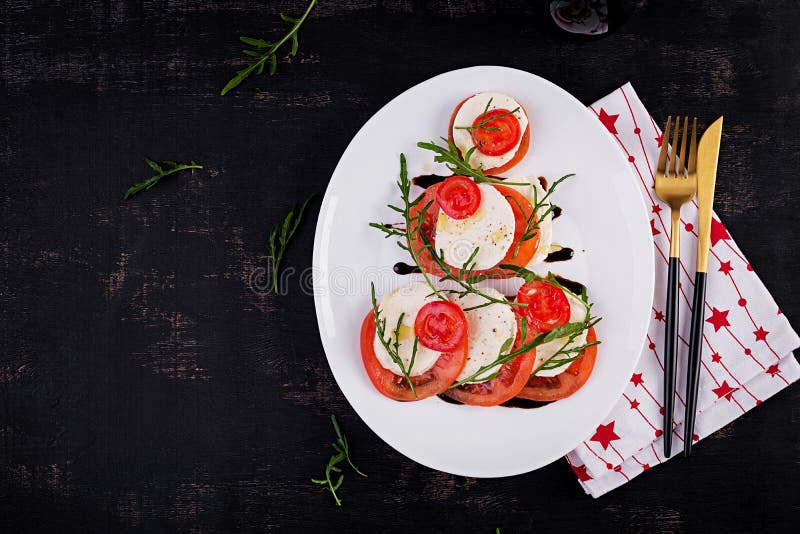 Salad Caprese with Tomato, Mozzarella and Arugula in the Shape of a