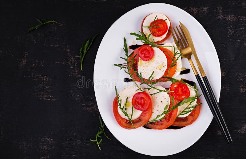Salad Caprese with Tomato, Mozzarella and Arugula in the Shape of a