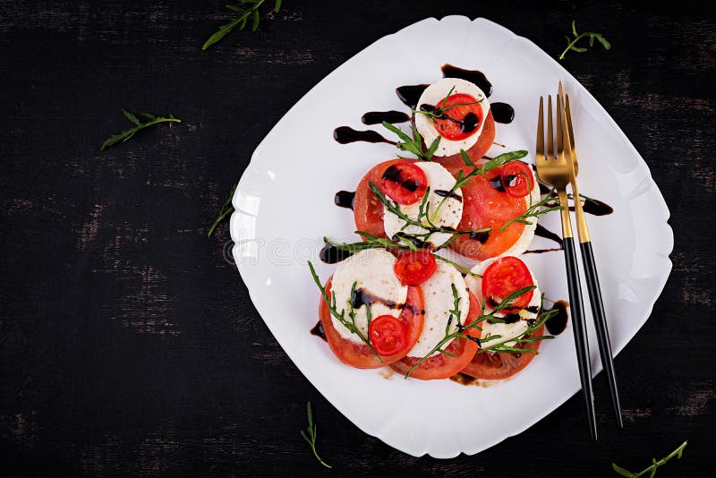 Salad Caprese with Tomato, Mozzarella and Arugula in the Shape of a