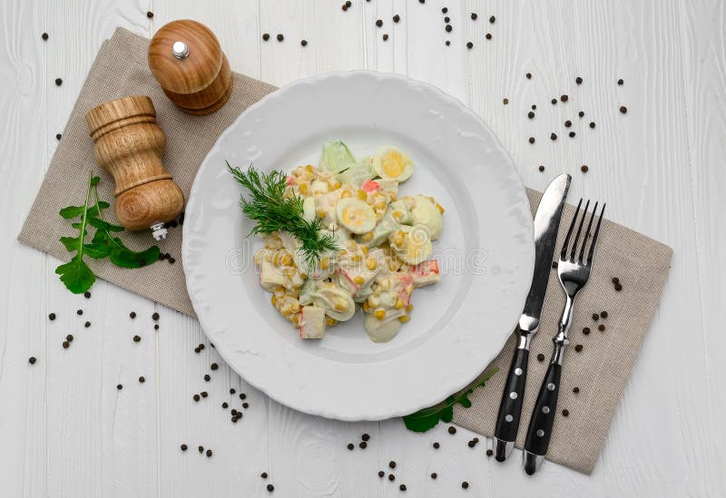 Salad with Crab Sticks, Sweet Corn, Cucumber, Eggs and Mayonnaise on