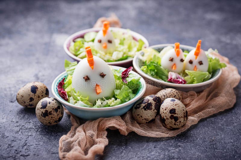 Salad with eggs in shape of chickens. Festive food. stock images