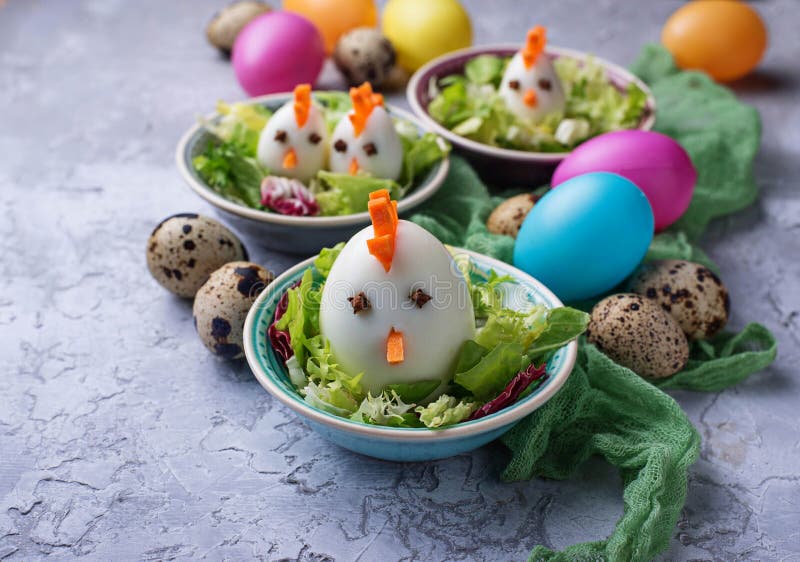 Salad with eggs in shape of chickens. Festive food. stock photos