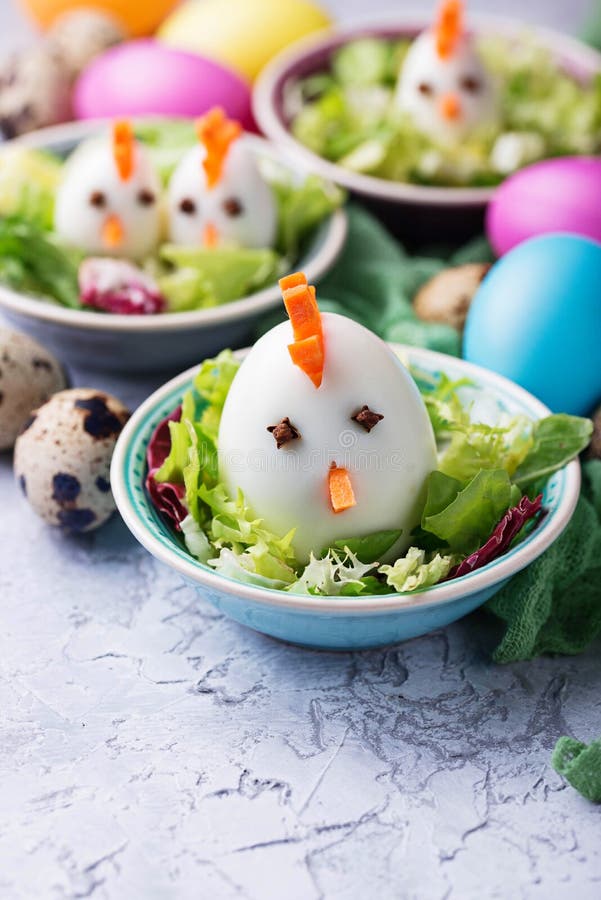 Salad with eggs in shape of chickens. Festive food. stock photo