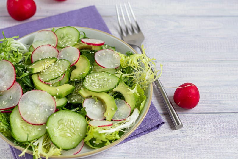 Salad of Fresh Cucumbers, Spinach Leaves, Arugula, Avocado. Served with ...