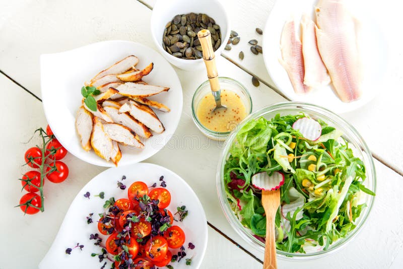 Salad with grilled meat, smoked fish and different vegetables.