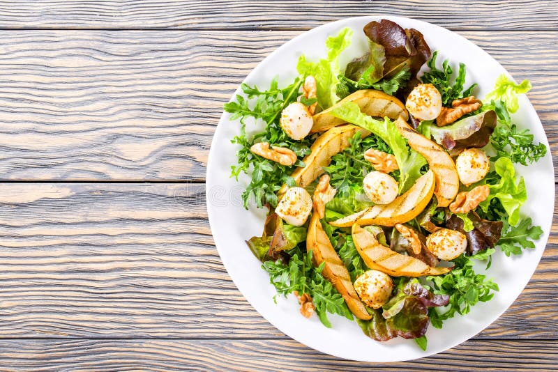 Salad with Grilled Pears, Baby Mozzarella Balls, Oakleaf Lettuce and Walnuts Stock Photo Image