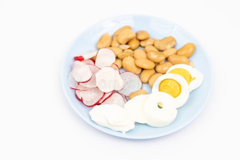 Salad med skivade kokta ägg, kokta bönor, skivade radisor och surgrädde arkivfoton Salad med skivade kokta ägg, kokta bönor, skivade radisor och surgrädde arkivfoton