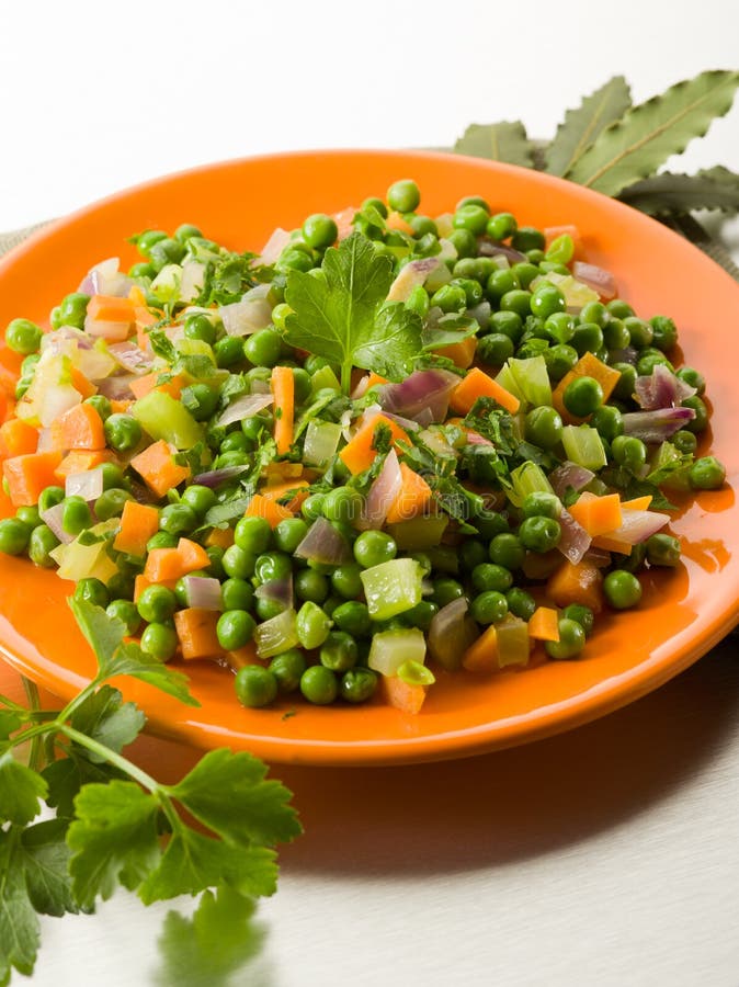 Salad with Peas and Mayonnaise, Served in a Cylinder on a Clay Plate