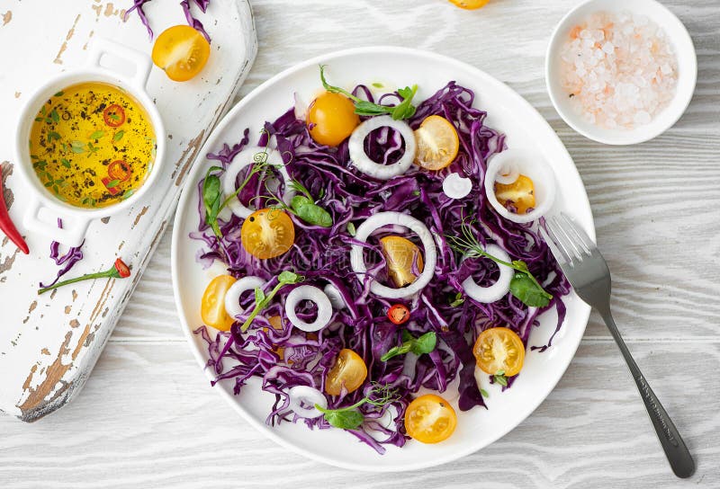 salad of red cabbage, yellow cherry tomatoes and onions stock image
