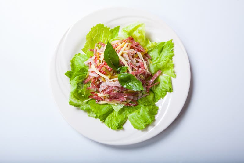 Salad from a Salami, Ham and Cheese on a White Plate Stock Photo